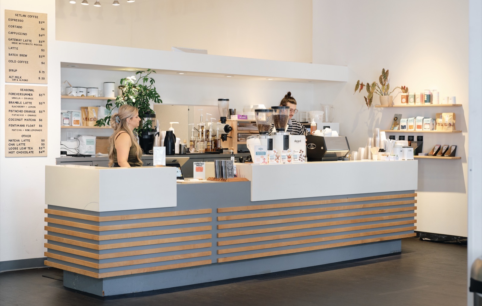 The Setlan Coffee counter inside MOCA Jacksonville, two baristas working beneath the menu board.